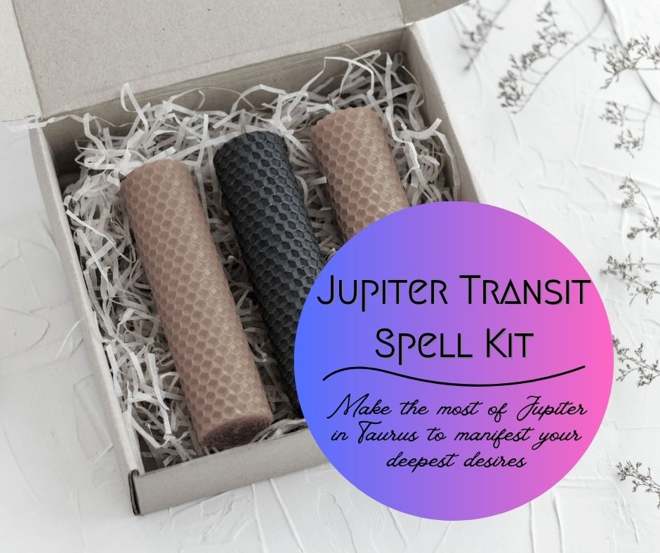 box of three rolled beeswax pillar candles alternating yellow and black with a purple ombre circle label saying Jupiter Transit Spell Kit, make the most of Jupiter in Taurus to manifest your deepest desires